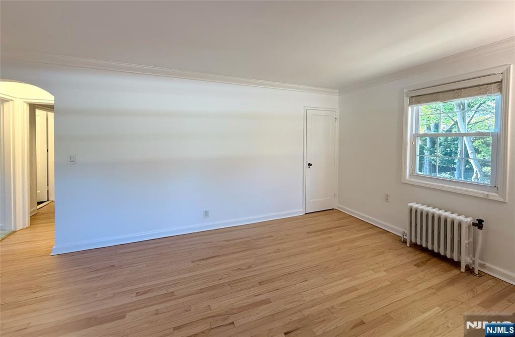 63 West Hudson Avenue, Unit C5 Englewood, NJ 07631 - Photo 5 of 19 a view of an empty room with wooden floor and a window