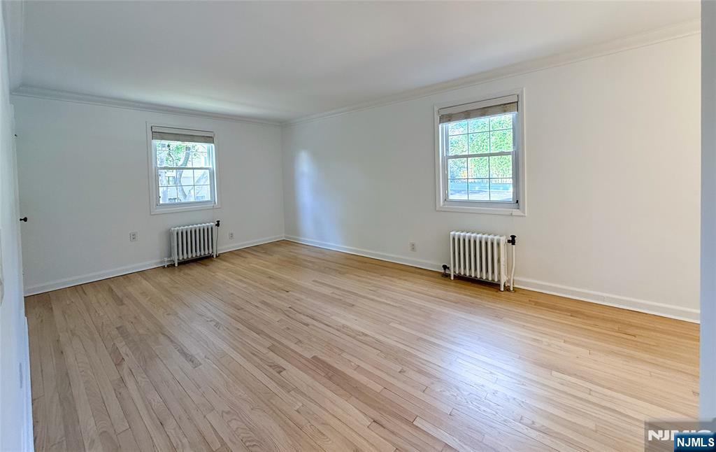 63 West Hudson Avenue, Unit C5 Englewood, NJ 07631 - Photo 6 of 19 an empty room with wooden floor and windows