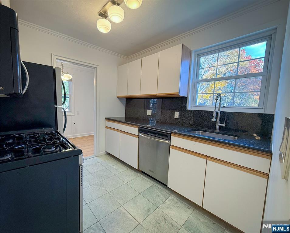 63 West Hudson Avenue, Unit C5 Englewood, NJ 07631 - Photo 10 of 19 a kitchen with stainless steel appliances granite countertop a sink stove and cabinets