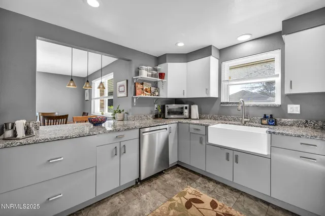 a kitchen with granite countertop white cabinets sink and white appliances