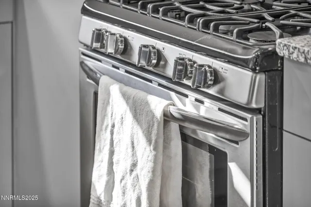 a kitchen with a faucet a stove and cabinets