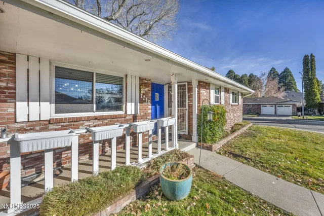 a view of a house with a chairs and table in a patio