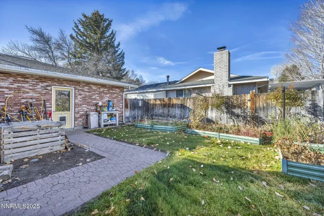 a view of a white house with a yard