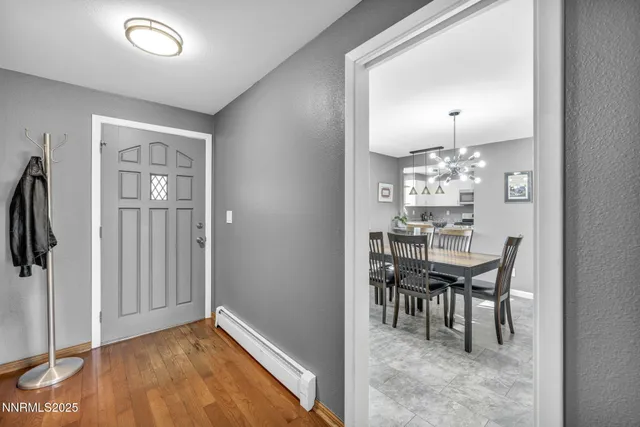 a view of a dining room with furniture and chandelier