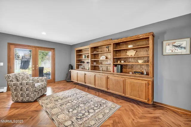 a living room with furniture rug and wooden floor