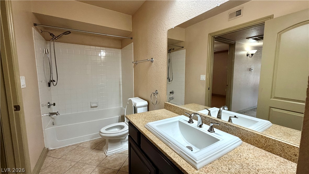 8101 West Flamingo Road, Unit 1082 Las Vegas, NV 89147 - Photo 19 of 23 A well-appointed bathroom features a modern vanity with a large mirror and an integrated tub and shower.