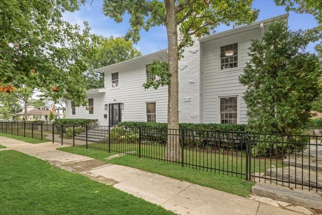 a view of a house with a backyard and a garden