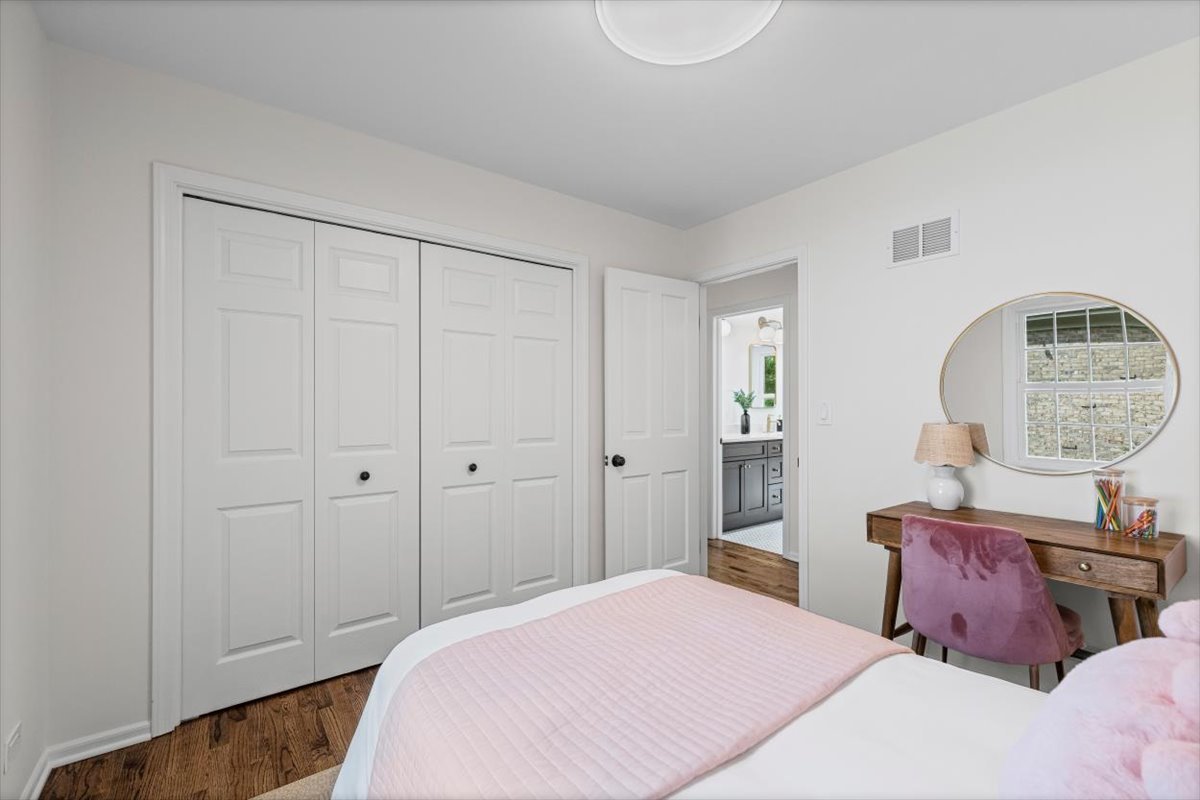 265 Randolph Street Glencoe, IL 60022 - Photo 22 of 34 a bedroom with a bed and a chandelier