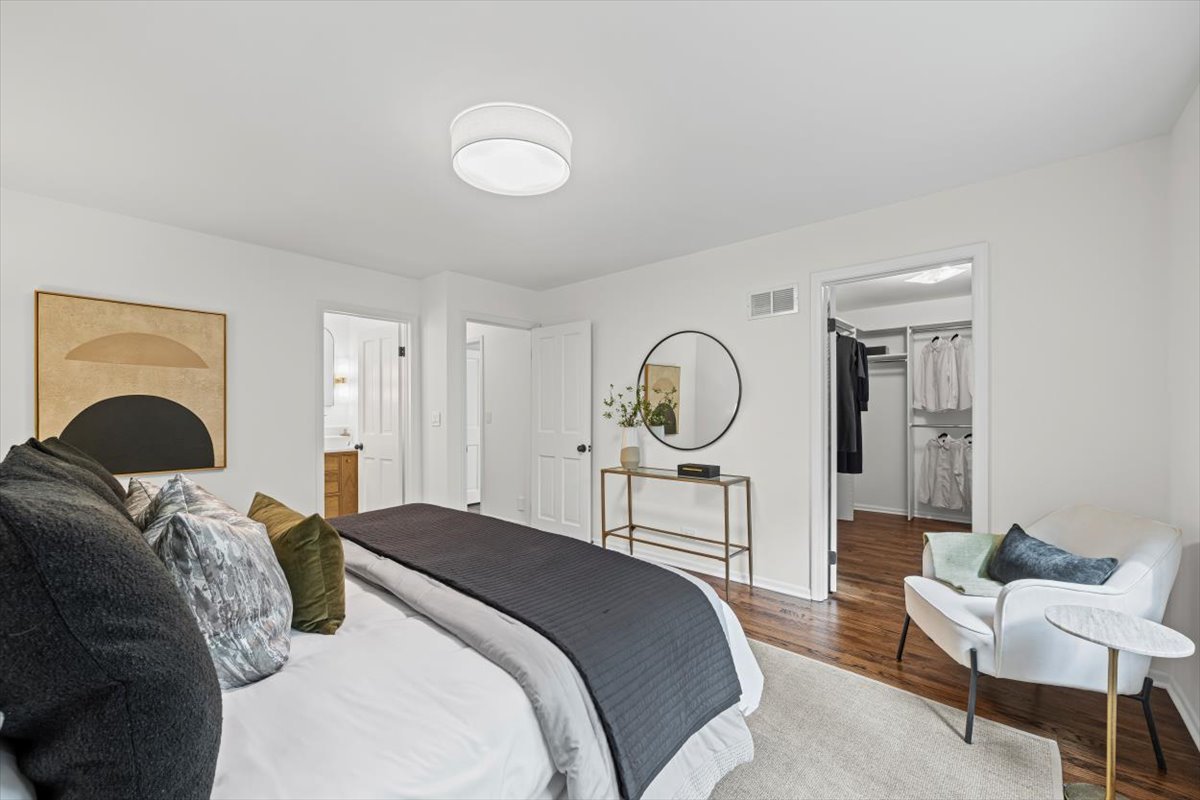 265 Randolph Street Glencoe, IL 60022 - Photo 25 of 34 a bedroom with a bed and a chandelier