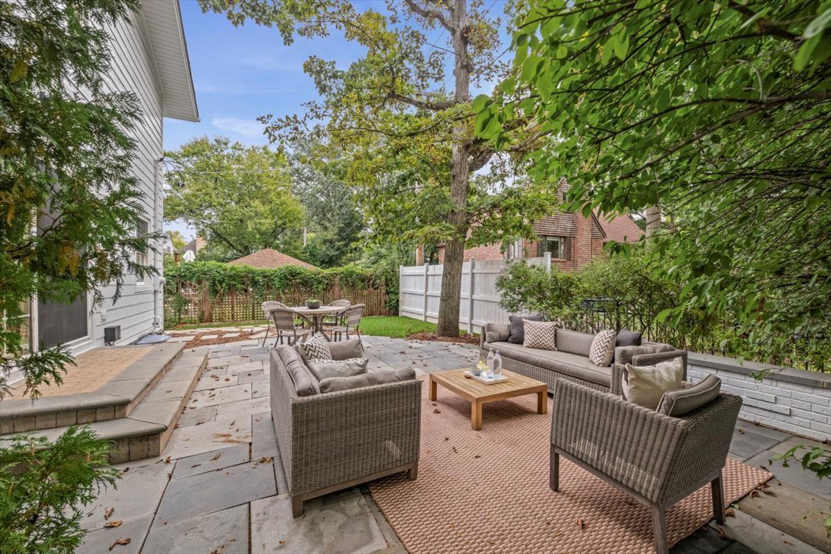 265 Randolph Street Glencoe, IL 60022 - Photo 33 of 34 a view of a patio with couches and chairs under an umbrella