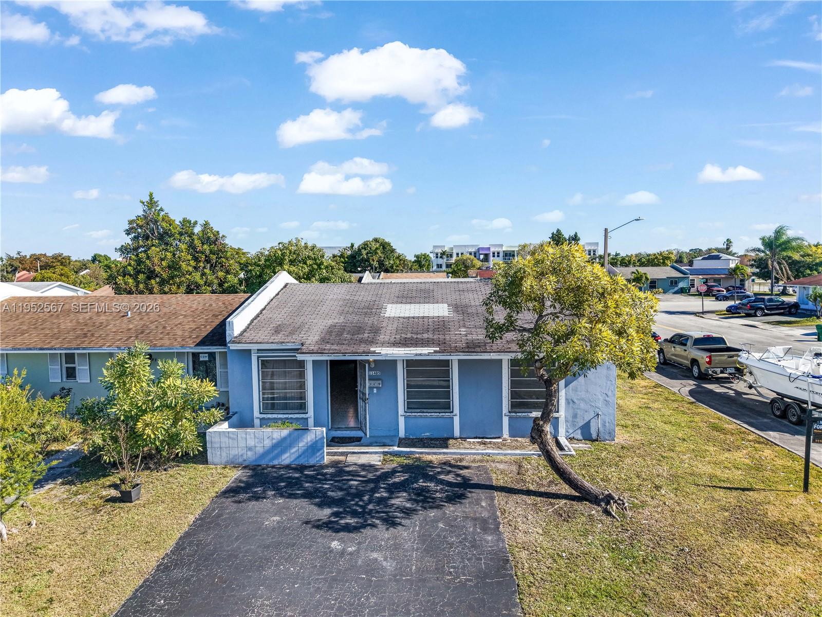a aerial view of a house with a yard and garage