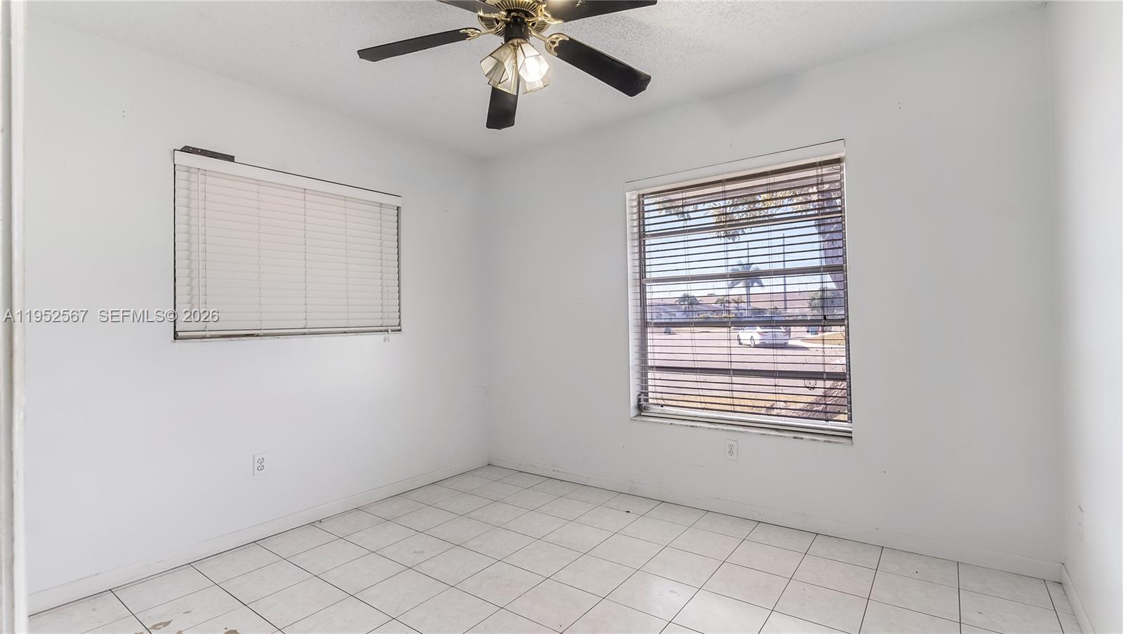 11405 Southwest 148th Terrace Miami, FL 33176 - Photo 17 of 28 an empty room with windows and fan