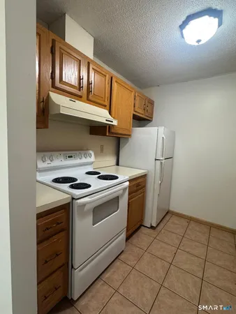 a kitchen with a stove and a refrigerator