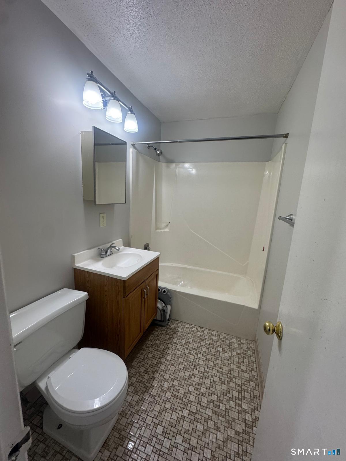 45 Stevens Street, Unit 5 Bridgeport, CT 06606 - Photo 7 of 8 a bathroom with a sink toilet and shower