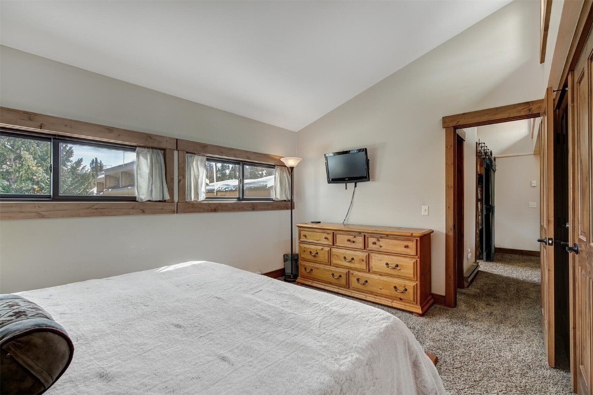 205 Primrose Path, Unit 3 Breckenridge, CO 80424 - Photo 11 of 32 a bedroom with a bed and a dresser