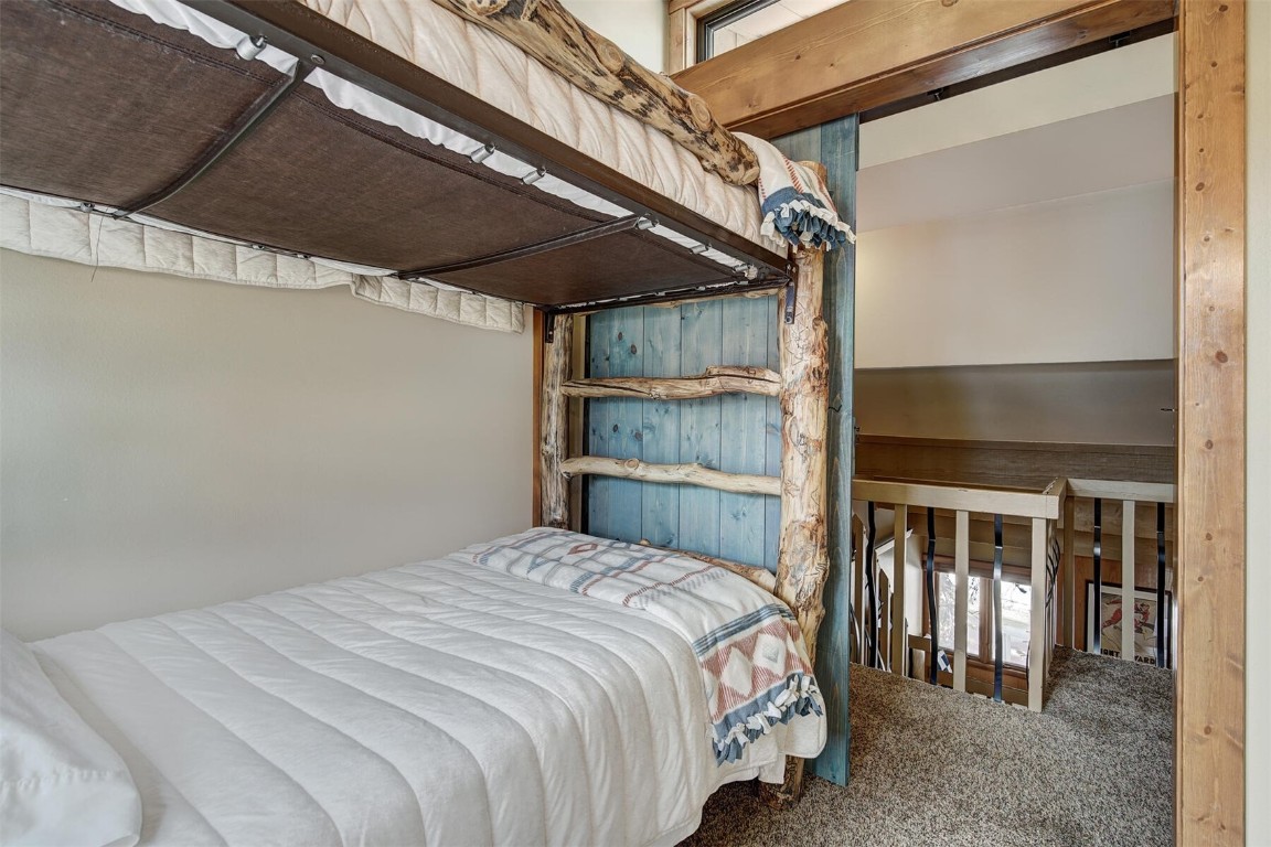 205 Primrose Path, Unit 3 Breckenridge, CO 80424 - Photo 13 of 32 a bedroom with a bed and a window