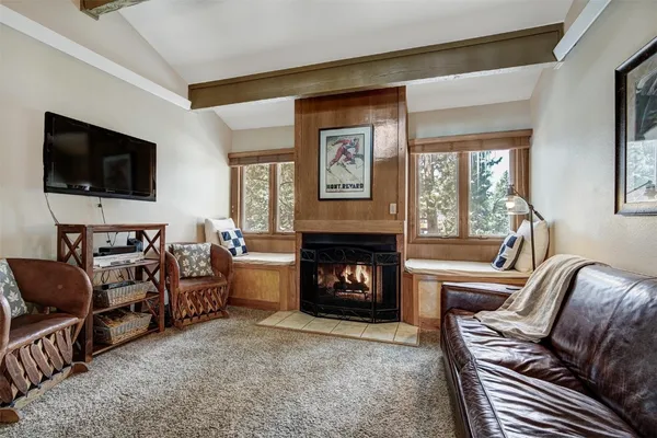 a living room with furniture a desk and chair with the wooden floor