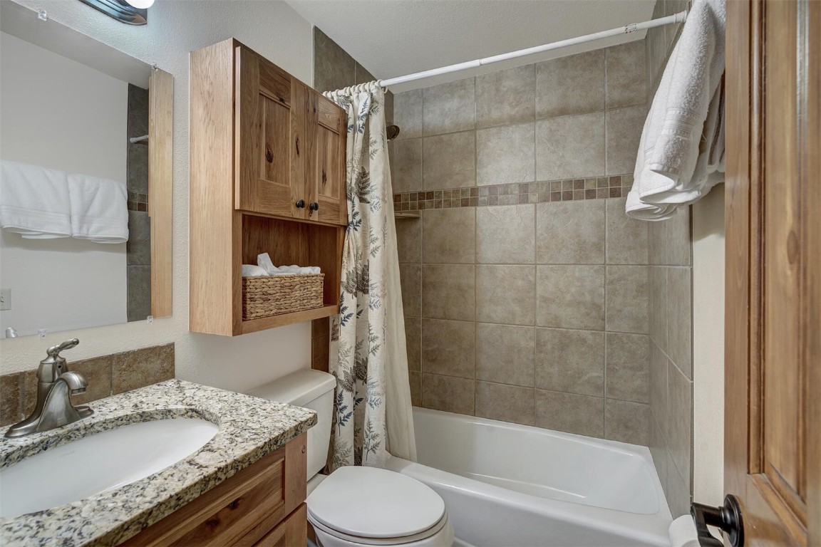 205 Primrose Path, Unit 3 Breckenridge, CO 80424 - Photo 7 of 32 a bathroom with a granite countertop sink toilet and shower