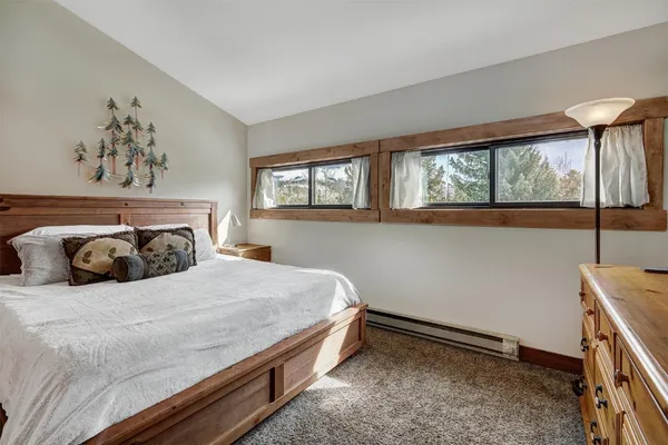 a bedroom with a bed and a dresser