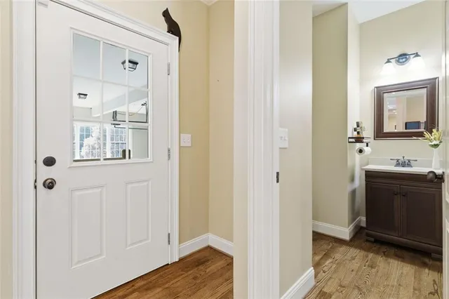 a bathroom with a double vanity sink a toilet and a mirror