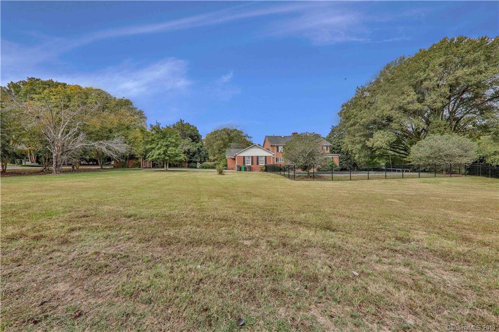 3319 Sharon Road Charlotte, NC 28211 - Photo 6 of 9 a view of a field with an trees in the background