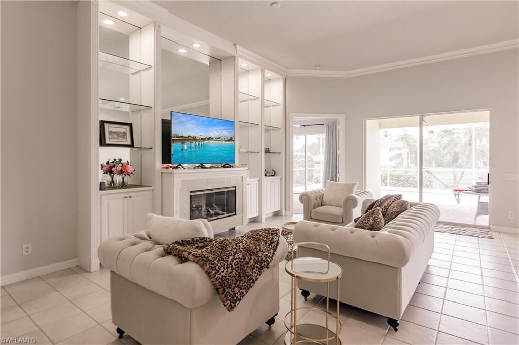5163 Inagua Way Naples, FL 34119 - Photo 12 of 50 Tiled living room featuring built in shelves