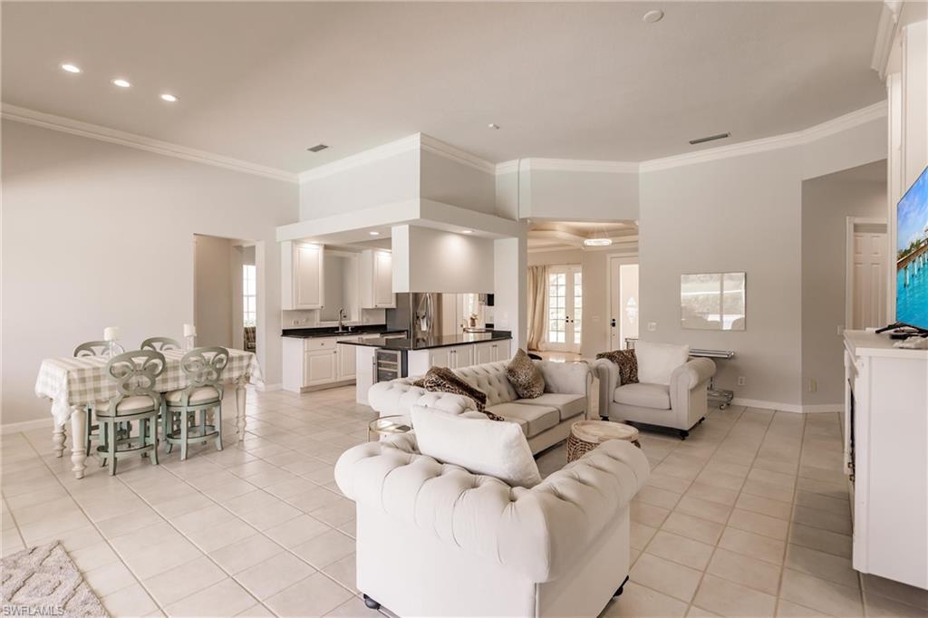 5163 Inagua Way Naples, FL 34119 - Photo 14 of 50 Tiled living room featuring crown molding and sink