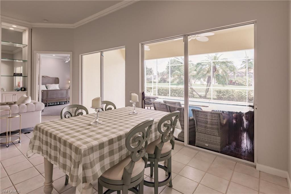 5163 Inagua Way Naples, FL 34119 - Photo 17 of 50 Dining room with light tile patterned floors and crown molding