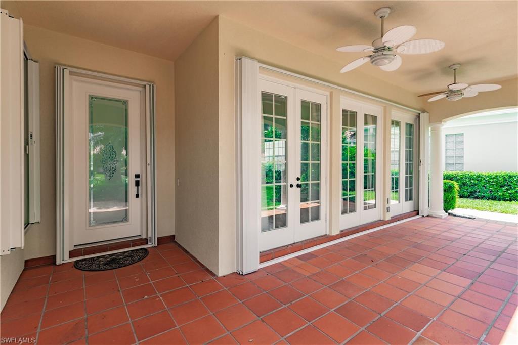 5163 Inagua Way Naples, FL 34119 - Photo 2 of 50 Entrance to property featuring ceiling fan, a patio area, and french doors