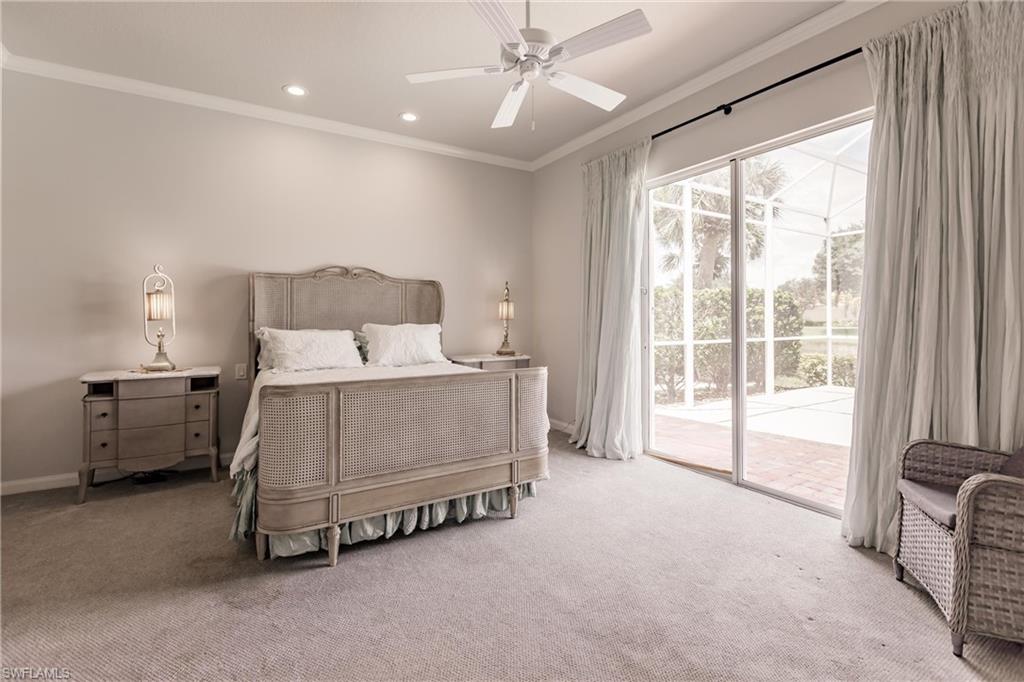 5163 Inagua Way Naples, FL 34119 - Photo 27 of 50 Bedroom featuring multiple windows, light colored carpet, crown molding, and access to outside