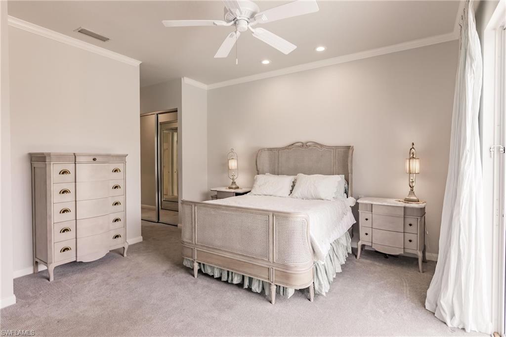 5163 Inagua Way Naples, FL 34119 - Photo 29 of 50 Bedroom featuring a closet, light colored carpet, crown molding, and ceiling fan