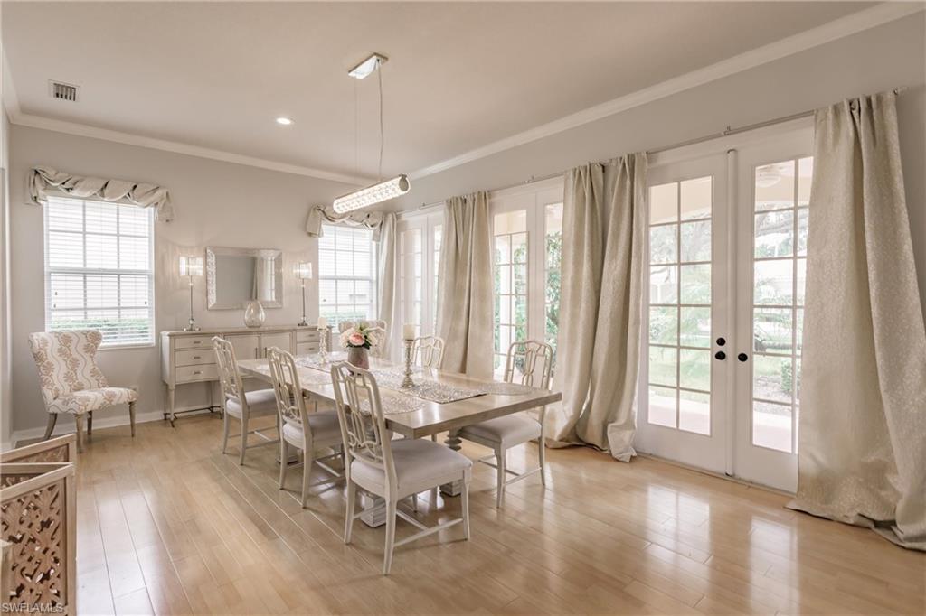 5163 Inagua Way Naples, FL 34119 - Photo 4 of 50 Dining space featuring ornamental molding, light hardwood / wood-style floors, and french doors
