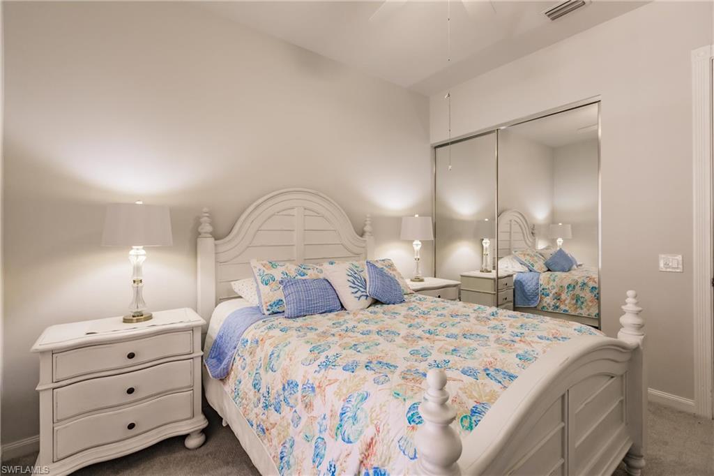 5163 Inagua Way Naples, FL 34119 - Photo 42 of 50 Carpeted bedroom with ceiling fan and a closet