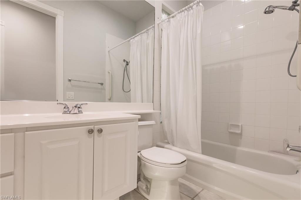 5163 Inagua Way Naples, FL 34119 - Photo 43 of 50 Full bathroom featuring shower / bath combo, tile patterned flooring, toilet, and vanity