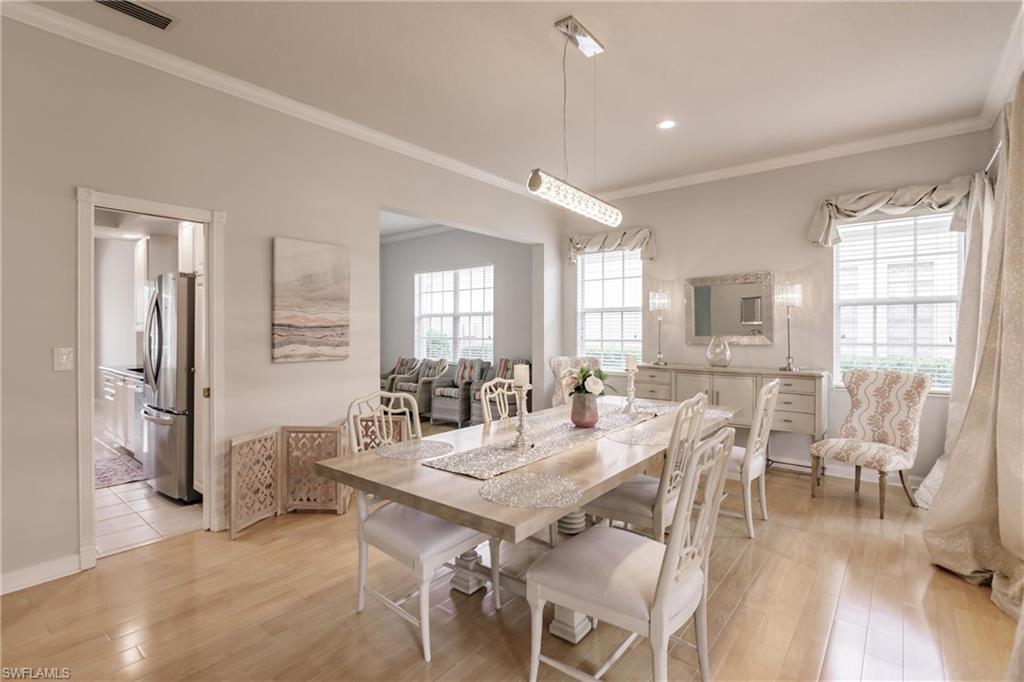 5163 Inagua Way Naples, FL 34119 - Photo 5 of 50 Dining room with crown molding and light hardwood / wood-style flooring