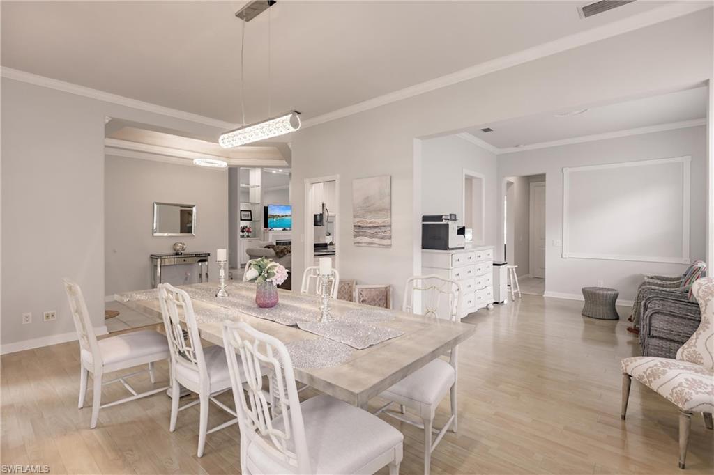 5163 Inagua Way Naples, FL 34119 - Photo 7 of 50 Dining space featuring crown molding and light wood-type flooring