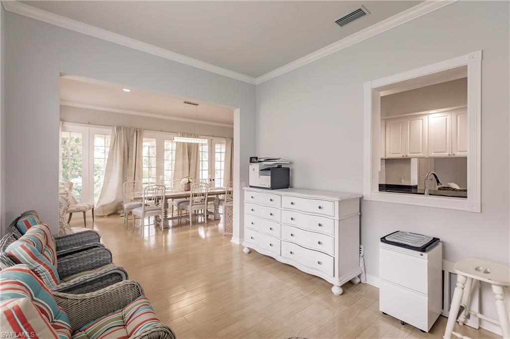 5163 Inagua Way Naples, FL 34119 - Photo 9 of 50 Living room with crown molding, sink, and light hardwood / wood-style floors