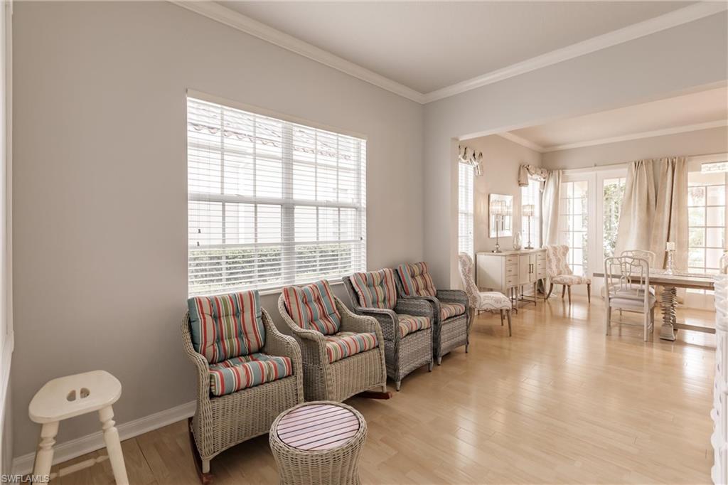5163 Inagua Way Naples, FL 34119 - Photo 10 of 50 Living room with crown molding and light hardwood / wood-style flooring