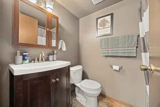 a bathroom with a sink a toilet and mirror