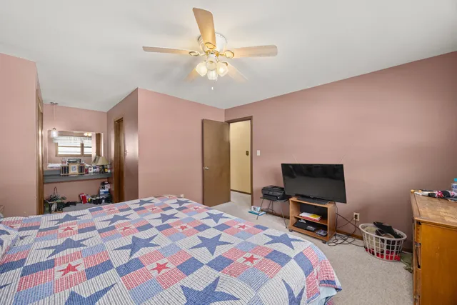 a bedroom with a bed and a flat screen tv in it