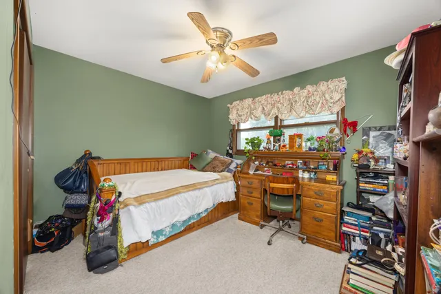 a bedroom with bed and a bookshelf