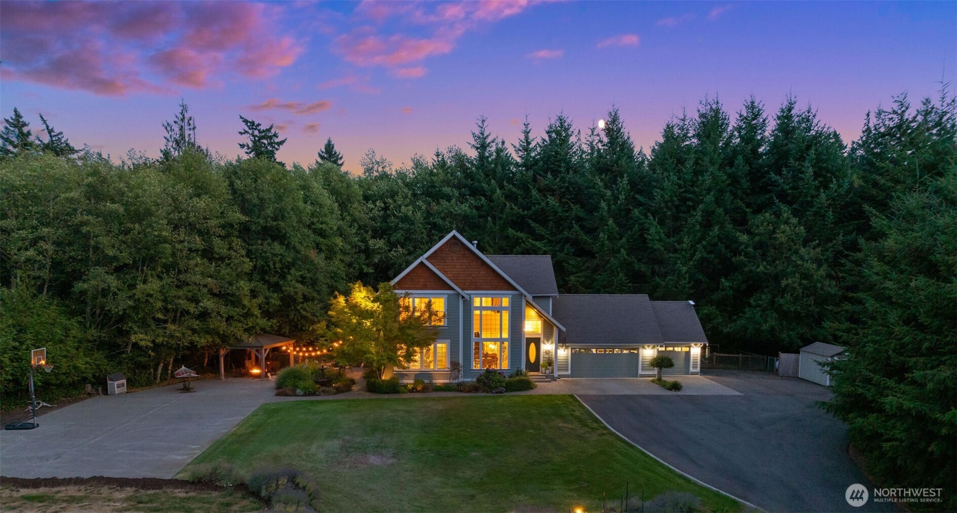 a view of a big house with a big yard and palm trees