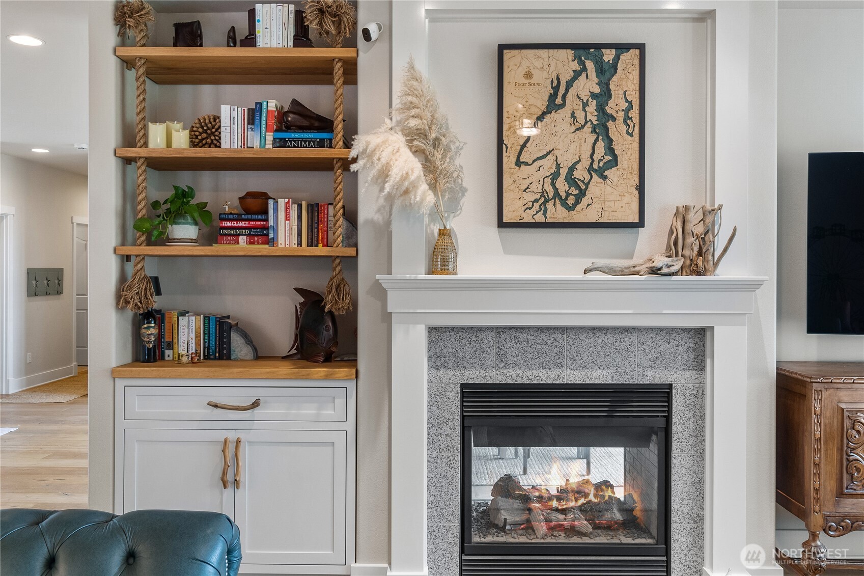 9044 Hunter Point Road Northwest Olympia, WA 98502 - Photo 12 of 40 a living room with bookshelf and a fireplace