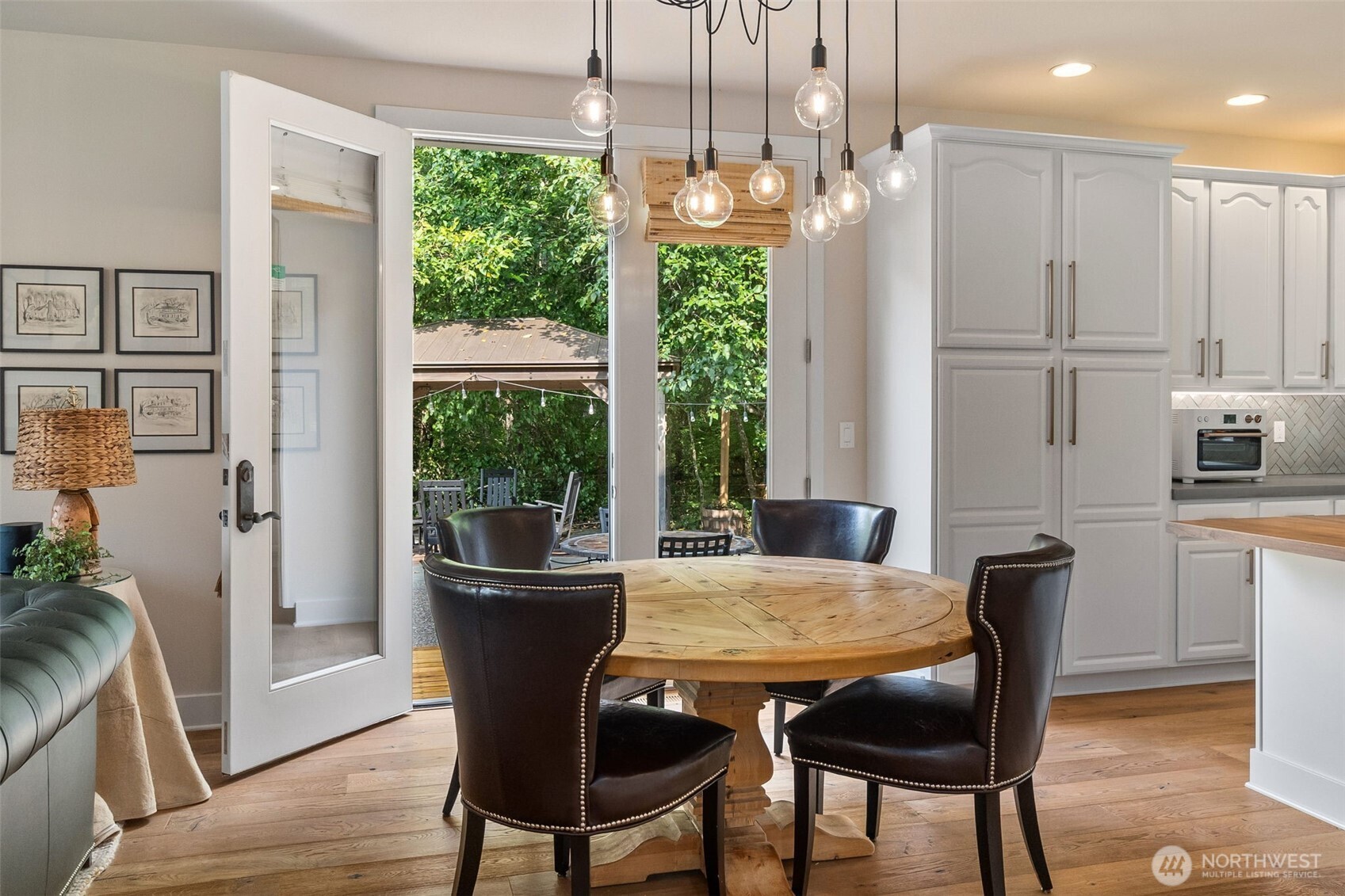 9044 Hunter Point Road Northwest Olympia, WA 98502 - Photo 13 of 40 a view of a dining room with furniture window and wooden floor
