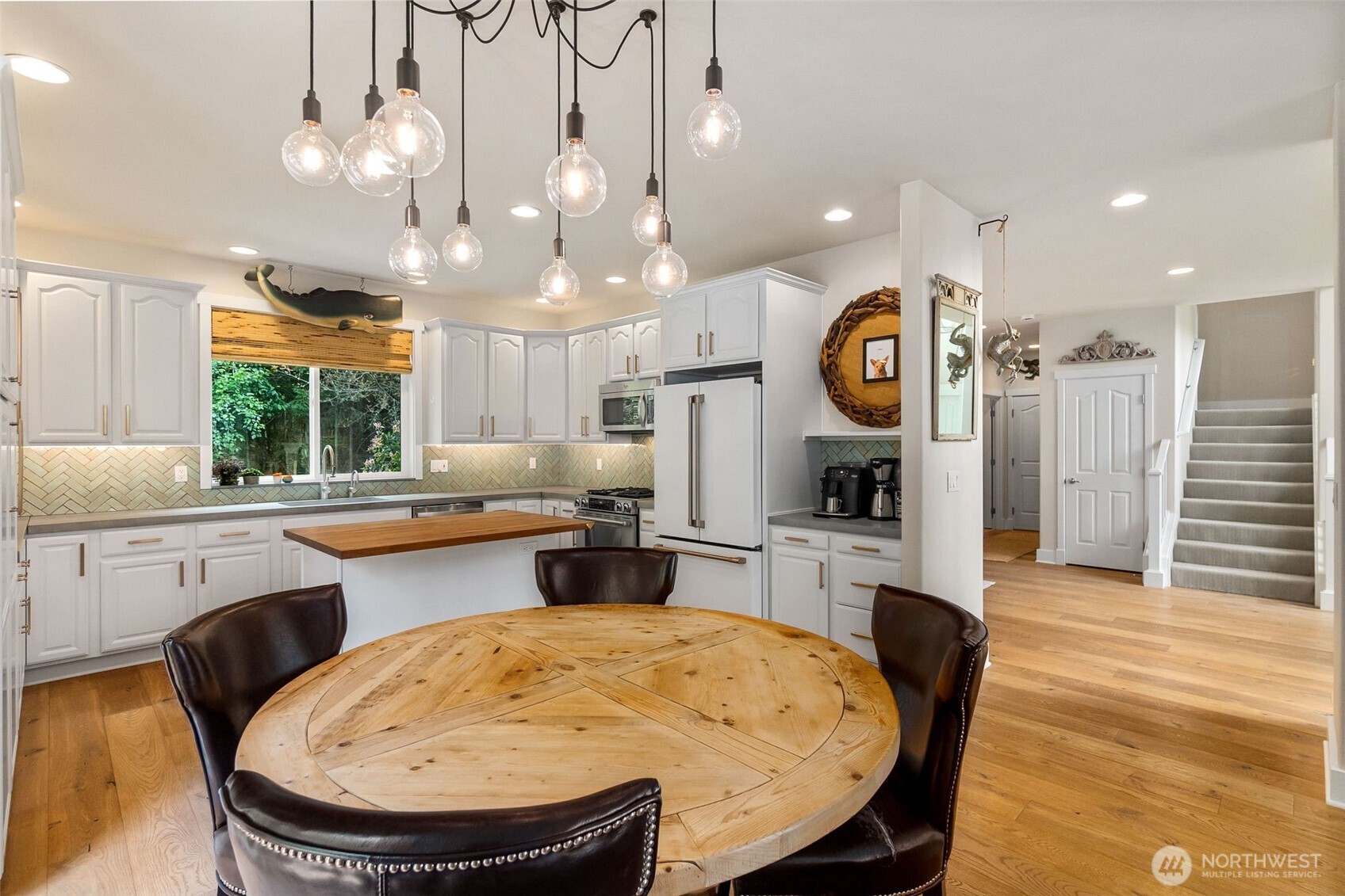 9044 Hunter Point Road Northwest Olympia, WA 98502 - Photo 15 of 40 a large kitchen with a table and chairs