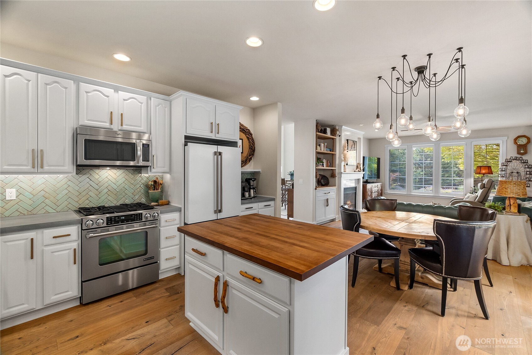 9044 Hunter Point Road Northwest Olympia, WA 98502 - Photo 16 of 40 a kitchen with kitchen island a large counter top space appliances and cabinets