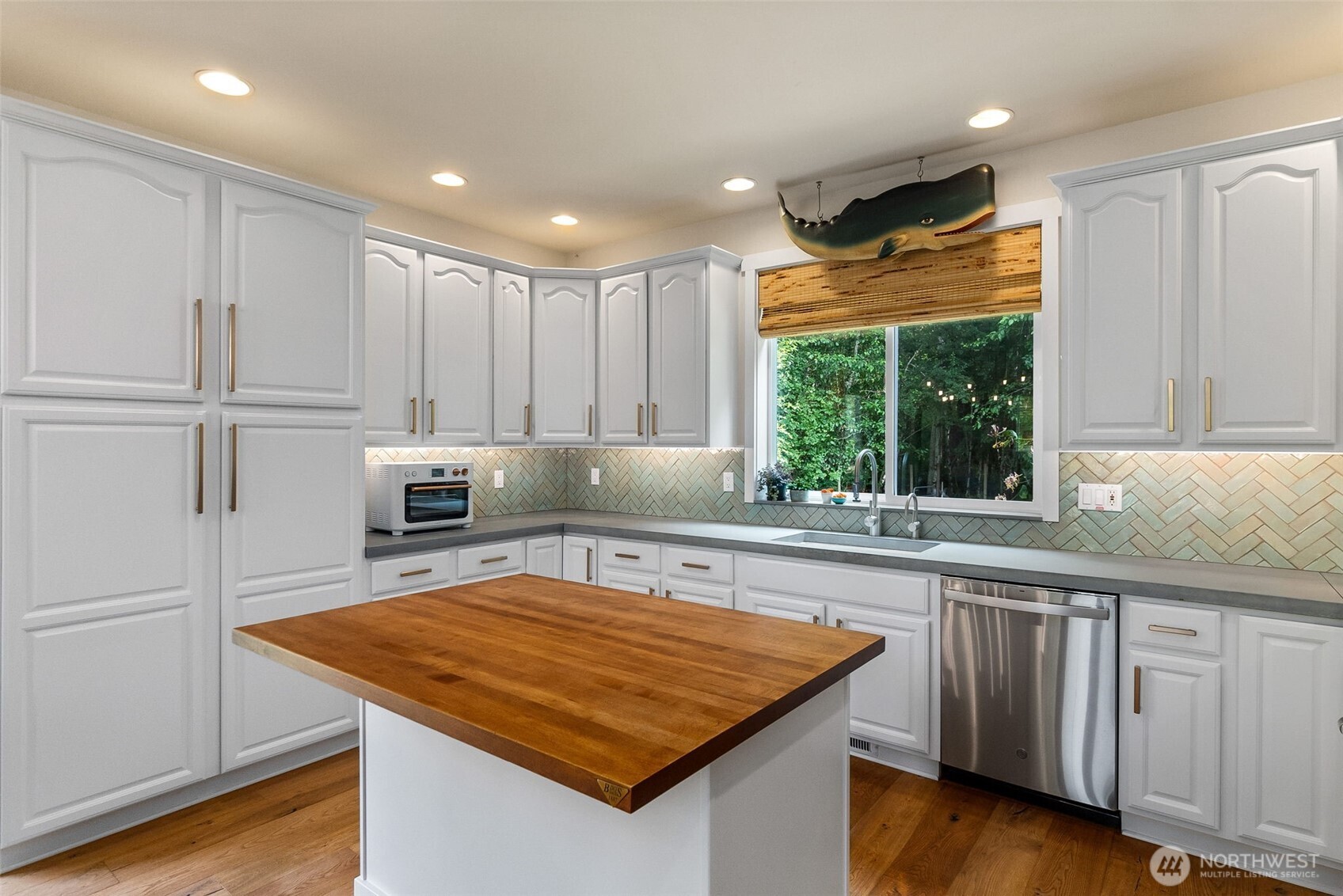 9044 Hunter Point Road Northwest Olympia, WA 98502 - Photo 17 of 40 a kitchen with wooden cabinets and white appliances