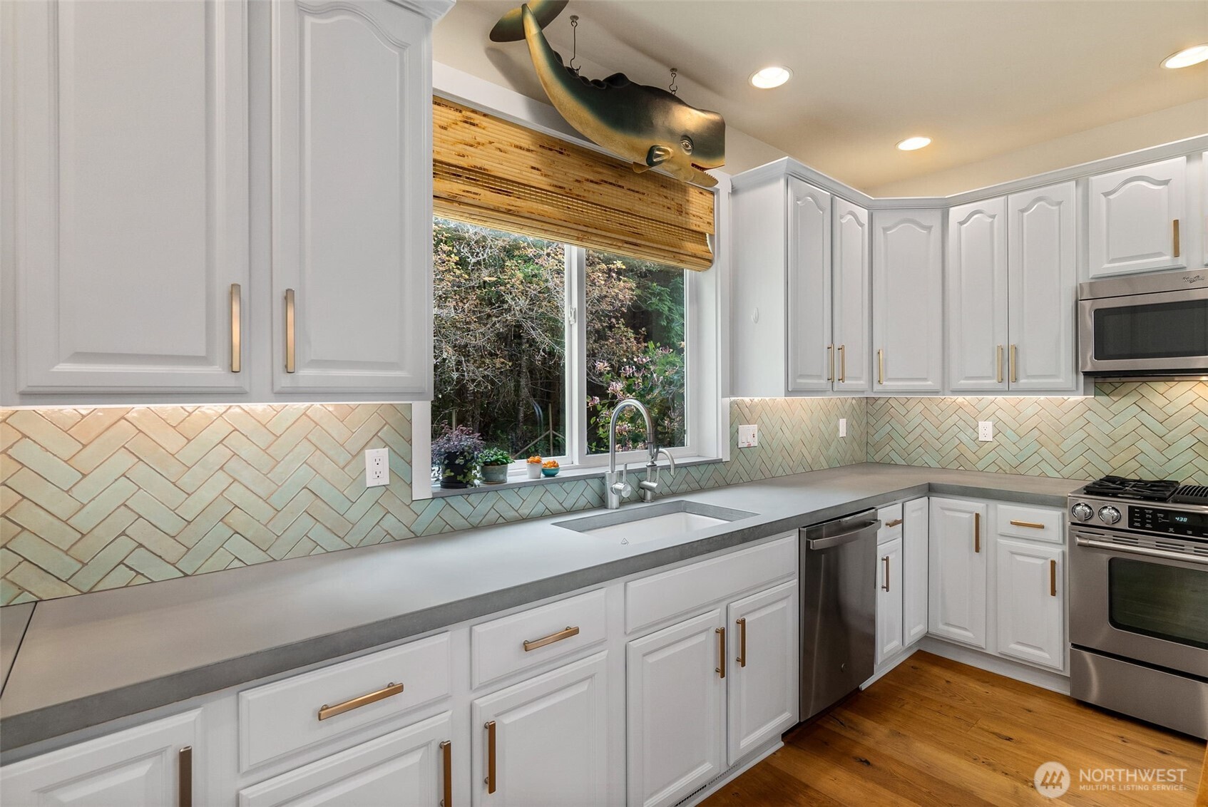 9044 Hunter Point Road Northwest Olympia, WA 98502 - Photo 18 of 40 a kitchen with appliances cabinets and a sink