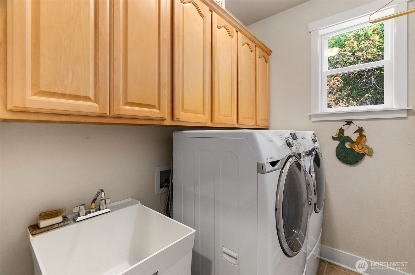 9044 Hunter Point Road Northwest Olympia, WA 98502 - Photo 20 of 40 a bathroom with a sink a toilet and a window