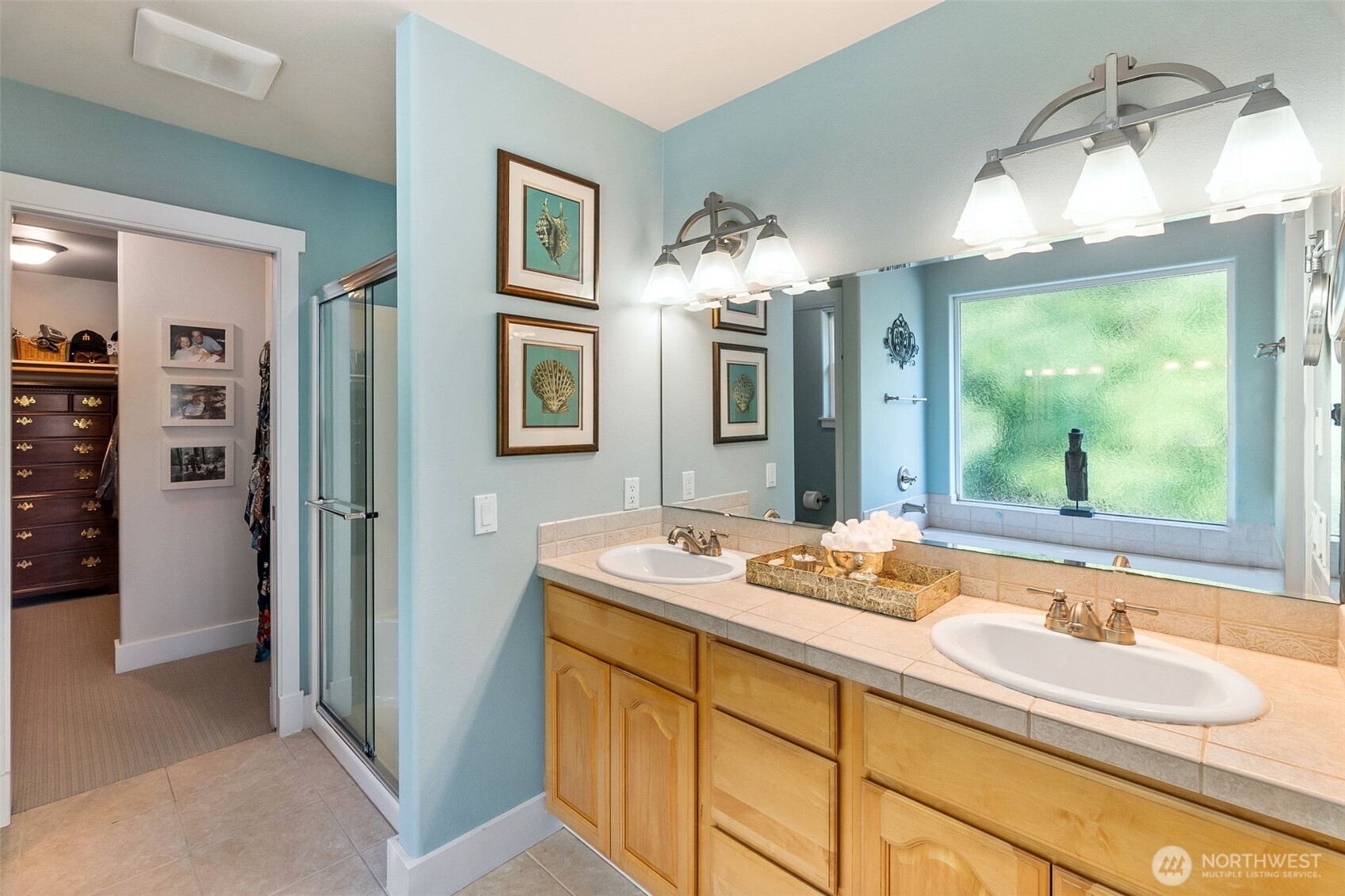 9044 Hunter Point Road Northwest Olympia, WA 98502 - Photo 26 of 40 a bathroom with a sink double vanity and a mirror